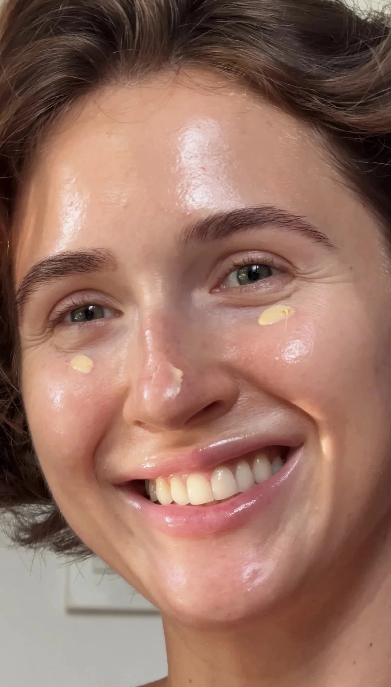 Skincare cream dotted on cheeks